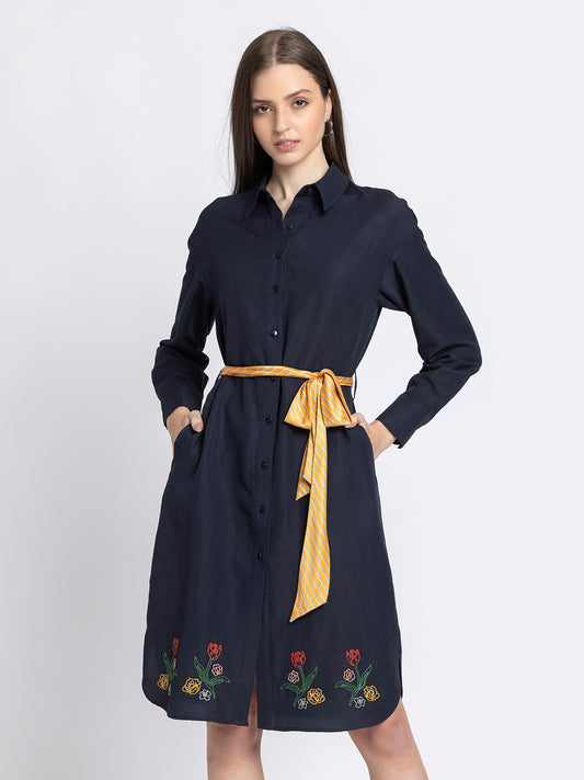 Model wearing black floral print dress with V-neck contrast collar wrap panel three-quarter slit sleeves pleated bottom relaxed fit