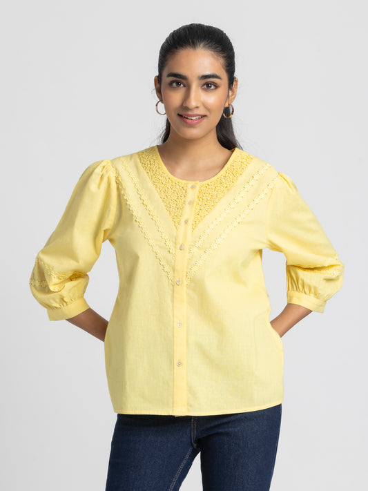 Model wearing yellow embroidered Ciara Shirt with round neck three-quarter sleeves button down front and relaxed fit