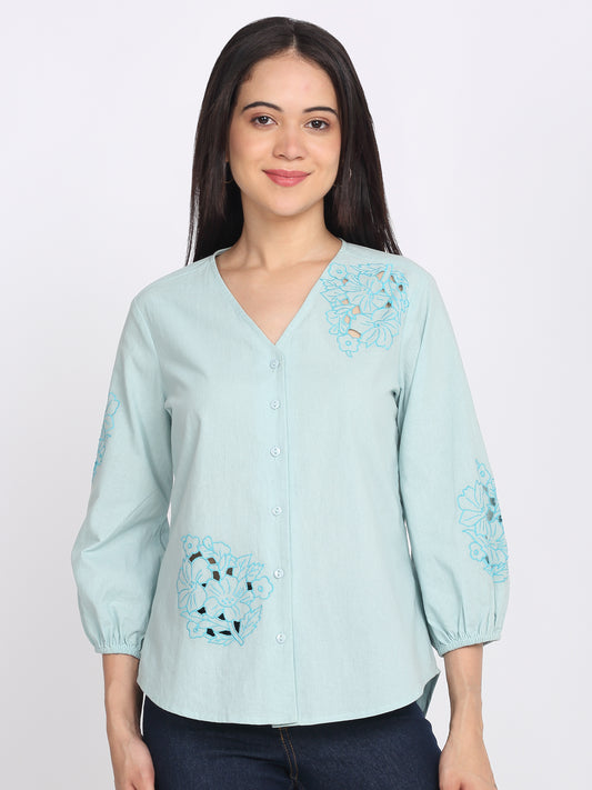 Blue cotton shirt with v-neck, button down front, embroidery at chest and sleeve, three-quarter elasticated sleeves, curved hem, relaxed fit, front view