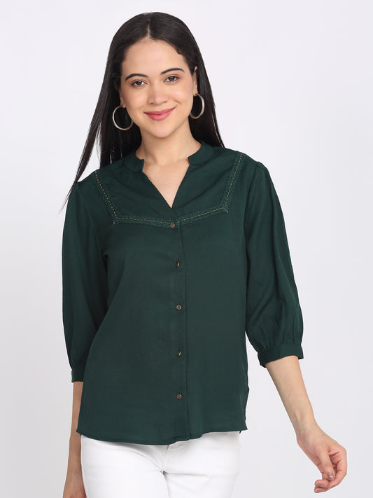 Green crinkled crepe shirt with band collar, three-quarter sleeves, lace detail at yoke, button down, relaxed fit curved hem, front view