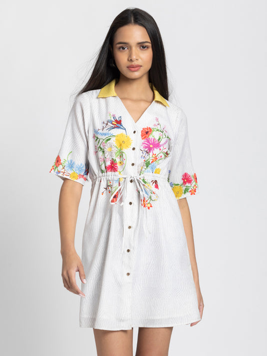 Model wearing white floral printed Adira Dress with V-neck collar button down front short sleeves and relaxed fit