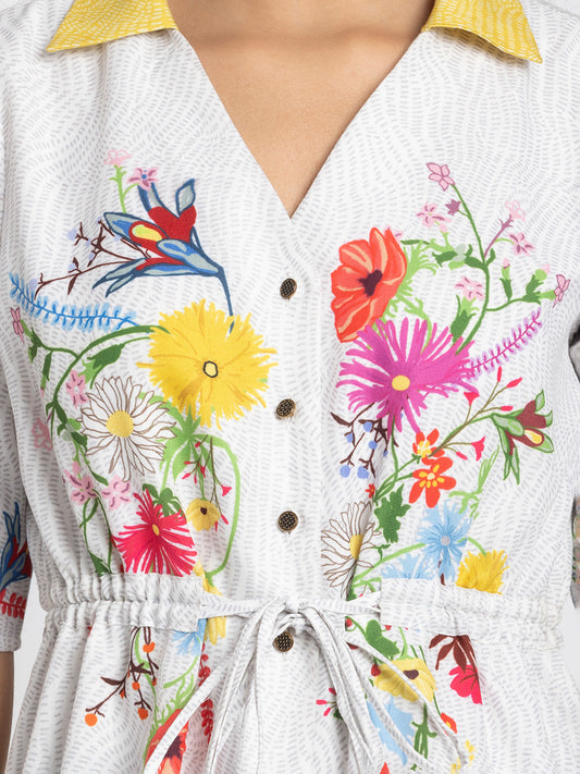 Close up of V-neck collar and tie up waist detail on white floral print Adira Dress showing soft breathable linen fabric