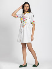 Side angle of white floral print Adira Dress with V-neck collar button front and soft linen fabric