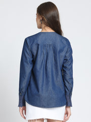 Back view blue denim top, gathers at yoke, high-low hemline, full cuff sleeves, relaxed fit
