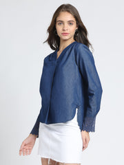 Model walking pose blue denim relaxed fit top, long sleeves, high-low hem, V-neck, pleat front