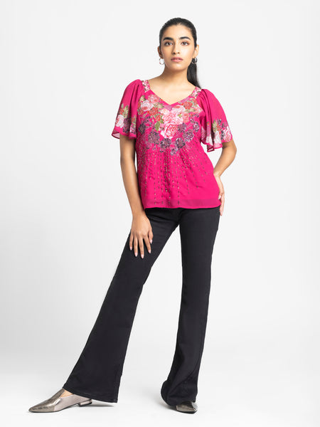 Full body shot of Ambre Top paired with black pants showing short flared sleeves printed fabric and relaxed fit