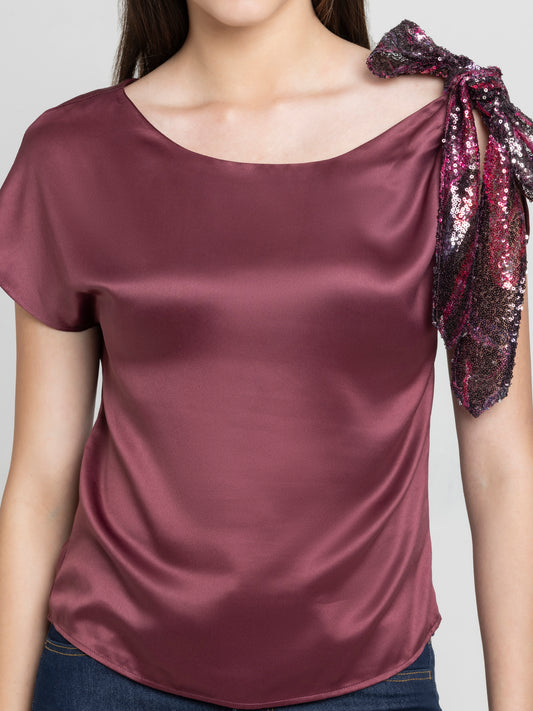Close up of printed sequin knot detail on shoulder of brown satin Bali Top with boat neckline