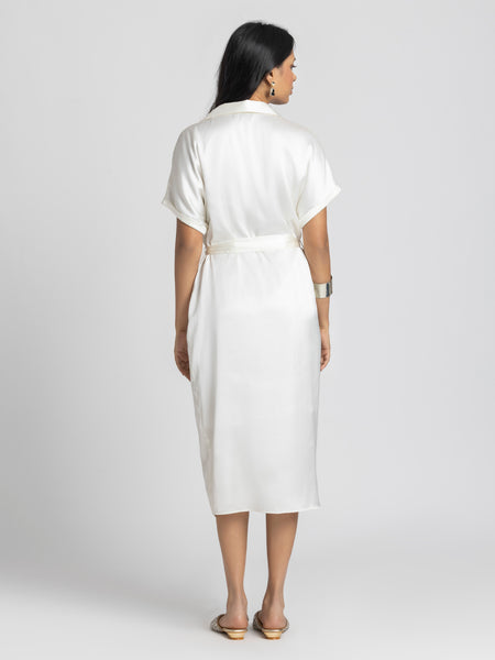 Rear view of Bernadette Dress showing shirt collar short sleeves pleats and belt tied at waist