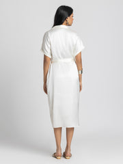 Rear view of Bernadette Dress showing shirt collar short sleeves pleats and belt tied at waist