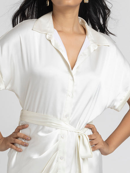 Close up of shirt collar and pleats detail at bottom on white satin Bernadette Dress