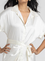 Close up of shirt collar and pleats detail at bottom on white satin Bernadette Dress