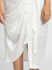 Close up of pleats detail at bottom and fabric texture on luxurious white satin Bernadette Dress