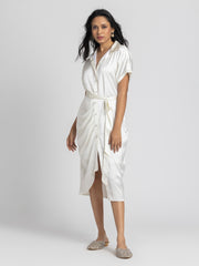 Side profile of Bernadette Dress displaying pleats detail belt and relaxed fit silhouette in satin 