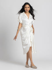 Model posing in Bernadette Dress with shirt collar pleats hem and tied waist belt with flowy satin fabric