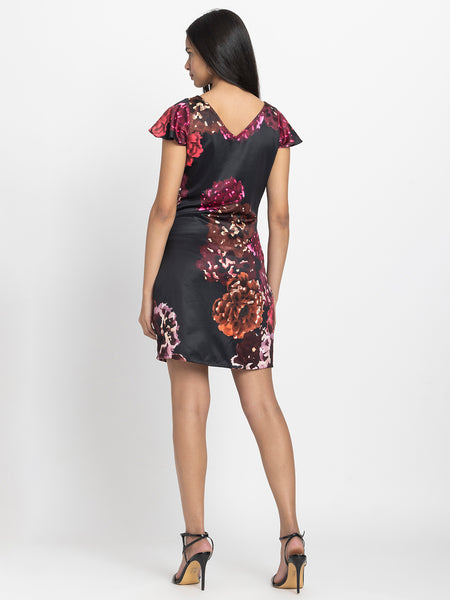 Rear view of Bianka Dress featuring back V-neck short cap sleeves and soft flowy satin fabric