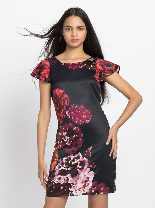 Model wearing black floral print Bianka Dress with scoop neck short cap sleeves and relaxed sheath fit