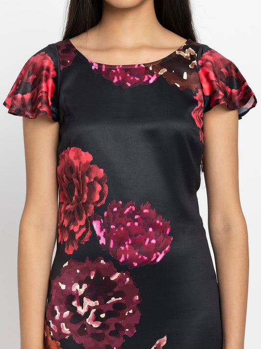 Close up of scoop neck and floral print on black satin Bianka Dress highlighting soft flowy fabric