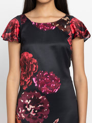 Close up of scoop neck and floral print on black satin Bianka Dress highlighting soft flowy fabric