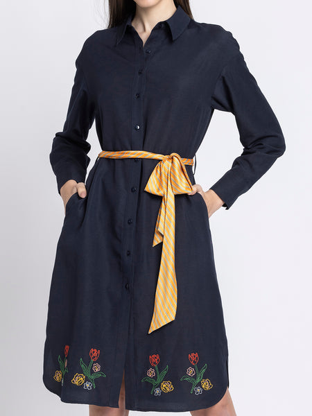 Close up of V-neck contrast collar and wrap panel on black floral satin dress showing three-quarter slit sleeves and pleated detail