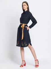 Side profile of black floral dress showing wrap panel three-quarter sleeves with slit and straight hem silhouette