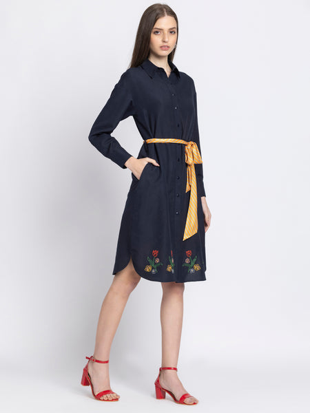 Model twirling in black floral dress showcasing pleated bottom relaxed fit and soft flowy satin fabric