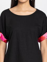 Detail view of black Laurina jersey t-shirt showing soft fabric texture and scoop neckline construction quality