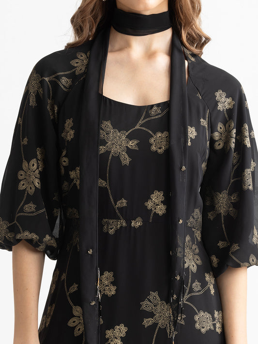 Close-up detail of gold foil print on black Bondi party dress in lightweight georgette fabric