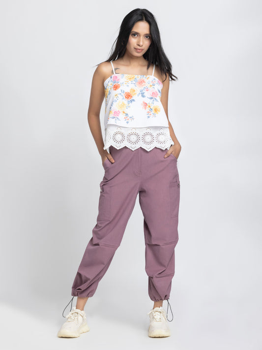Model standing wearing Capri Pants with white top highlighting relax fit high-rise waist and ankle toggles