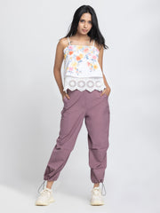 Model standing wearing Capri Pants with white top highlighting relax fit high-rise waist and ankle toggles