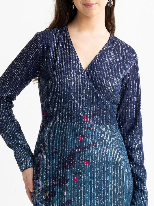 Close-up detail of floral print and sequin fabric at hem of blue Carey slim fit party dress