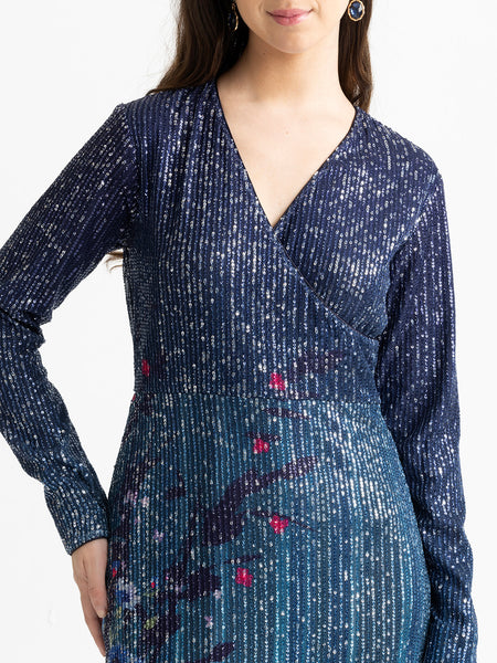 Close-up detail of floral print and sequin fabric at hem of blue Carey slim fit party dress