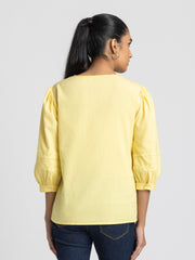 Rear view of yellow embroidered Ciara Shirt showing relaxed fit rounded hem and embroidery on yoke