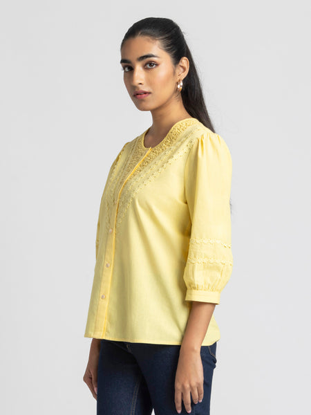 Side profile of yellow embroidered Ciara Shirt with curved hem button down front and breathable cotton fabric