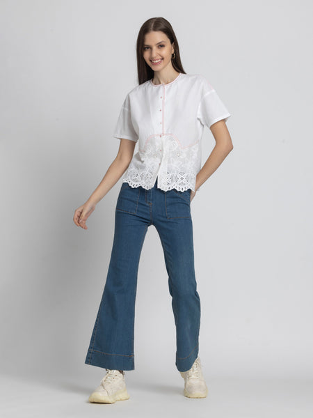 Full body shot of model in Cosette Shirt paired with jeans showing relaxed fit short sleeves and straight hem
