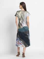 Rear view of Dorina Dress featuring drop shoulder sleeves asymmetric hem and soft flowy satin fabric