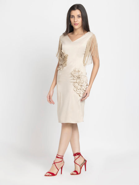 Model walking in beige sheath party dress with fringes and floral sequin details, fitted silhouette