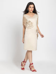 Side view of beige satin sheath dress with fringed sleeves, sequin embroidery, fitted shape, straight hem