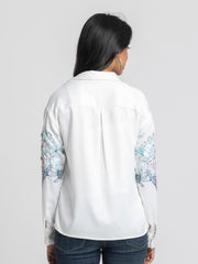  Rear view of Georgia Shirt revealing relaxed fit curved hem and elegant white satin fabric with floral print