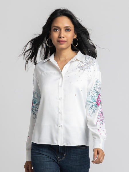 Model wearing white satin Georgia Shirt with floral print spread collar full cuff sleeves and curved hem