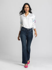 Full body view of Georgia Shirt paired with jeans showing button down front relaxed fit and soft satin fabric