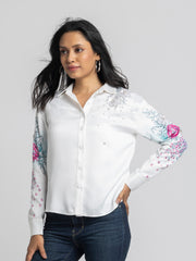 Model in motion wearing Georgia Shirt highlighting embroidered sleeves button down front and relaxed fit