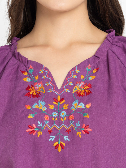 Close up of colorful front embroidery and frill detail on neckline of purple Gorgeouso Top