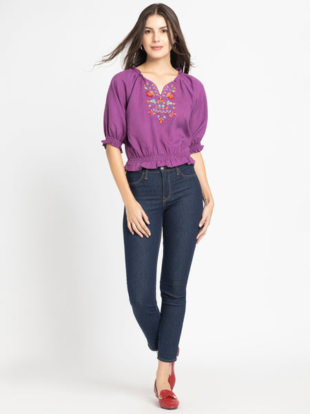 Full body shot of Gorgeouso Top with short sleeves smocking on hem styled with dark jeans