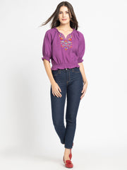 Full body shot of Gorgeouso Top with short sleeves smocking on hem styled with dark jeans