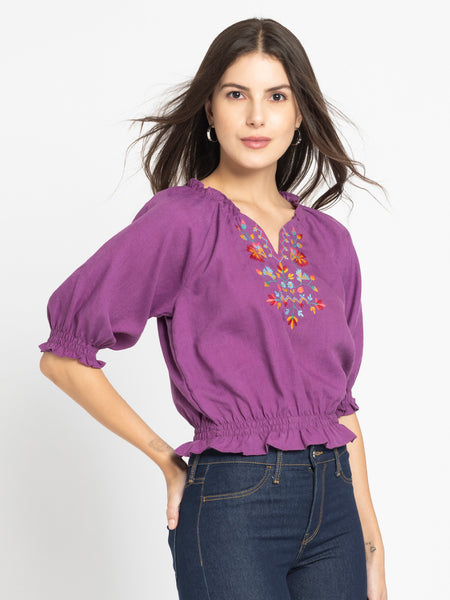 Side view of purple Gorgeouso Top highlighting smocking details frill neckline and short sleeves