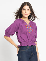 Side view of purple Gorgeouso Top highlighting smocking details frill neckline and short sleeves