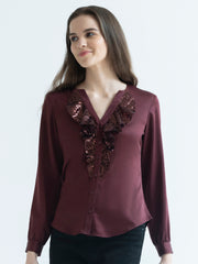 Angled pose of model wearing Gramercy Shirt showing V-neck frill detail and relaxed fit in satin