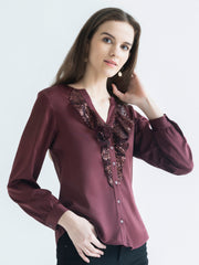 Side view of brown Gramercy Shirt highlighting full sleeves sequin frill and curved hem silhouette