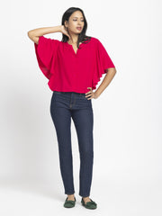 Full body shot of Jacqueline Shirt paired with dark jeans showing relax fit flared sleeves and curved hem