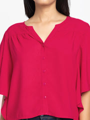 Close up of V-neck and button placket on fuchsia Jacqueline Shirt showing soft viscose rayon fabric and luxe texture